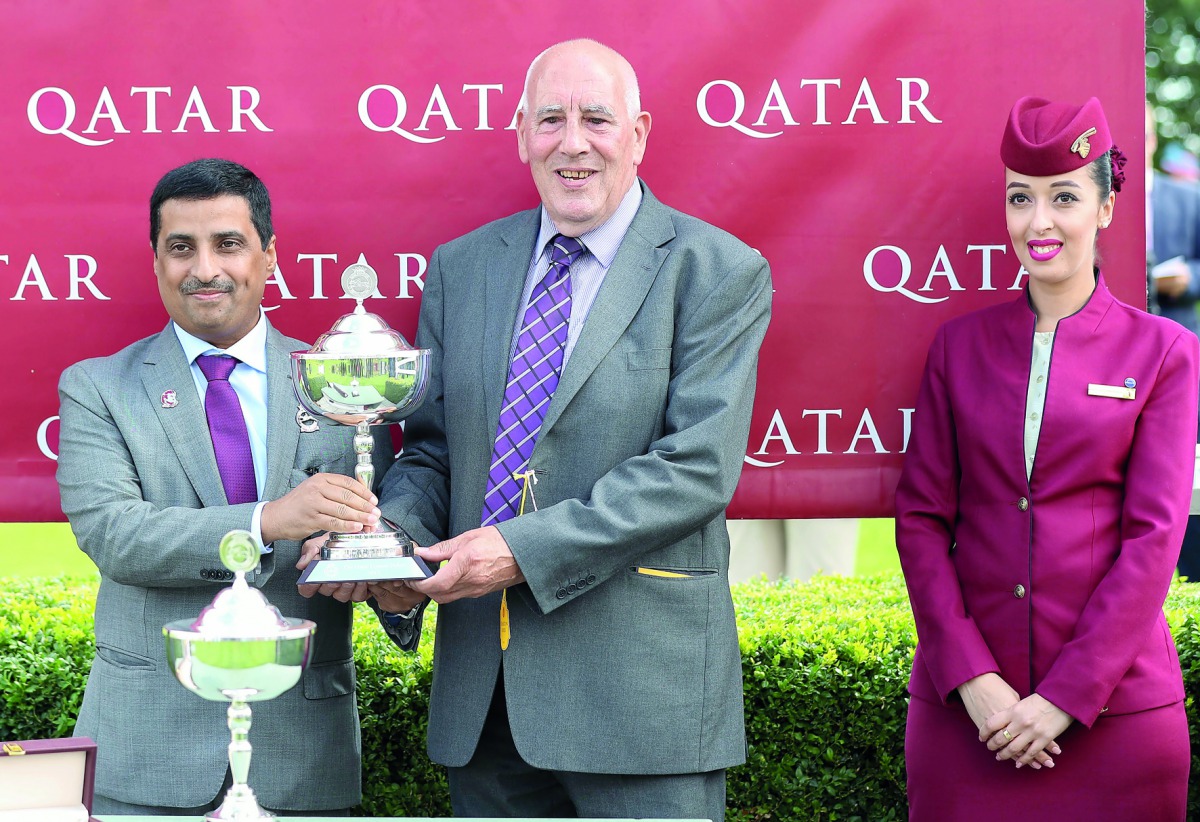 Qatar Racing and Equestrian Club (QREC) Board Member, Khalid bin Mohammed Al Ali presenting the winners’ trophy to John Cook, owner of Breton Rock who won the G2 Qatar Lennox Stakes on the opening day of the Qatar Goodwood Festival in West Sussex, England