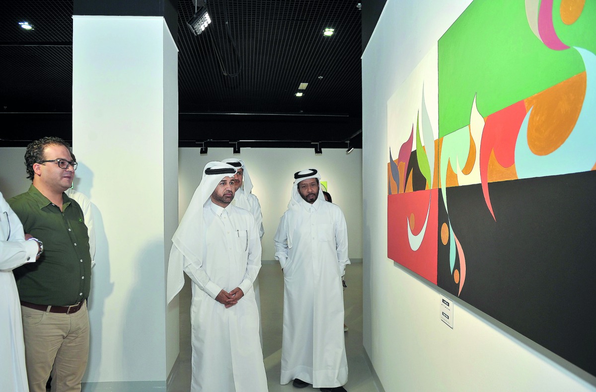 Katara General Manager Dr Khalid bin Ibrahim Al Sulaiti (centre) looks at the painting by Doha-based Syrian artist Rami Khouri at the opening of ‘Rhythm of the Alphabet’ exhibition yesterday at Katara Building 19. Pic: Baher Amin / The Peninsula