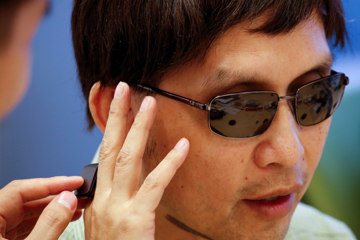 Origami Labs co-founder and CEO Kevin Wong and his visually impaired father Peter test an Orii smart ring at Hong Kong Cyberport in Hong Kong August 3 2017 Reuters/Bobby Yip