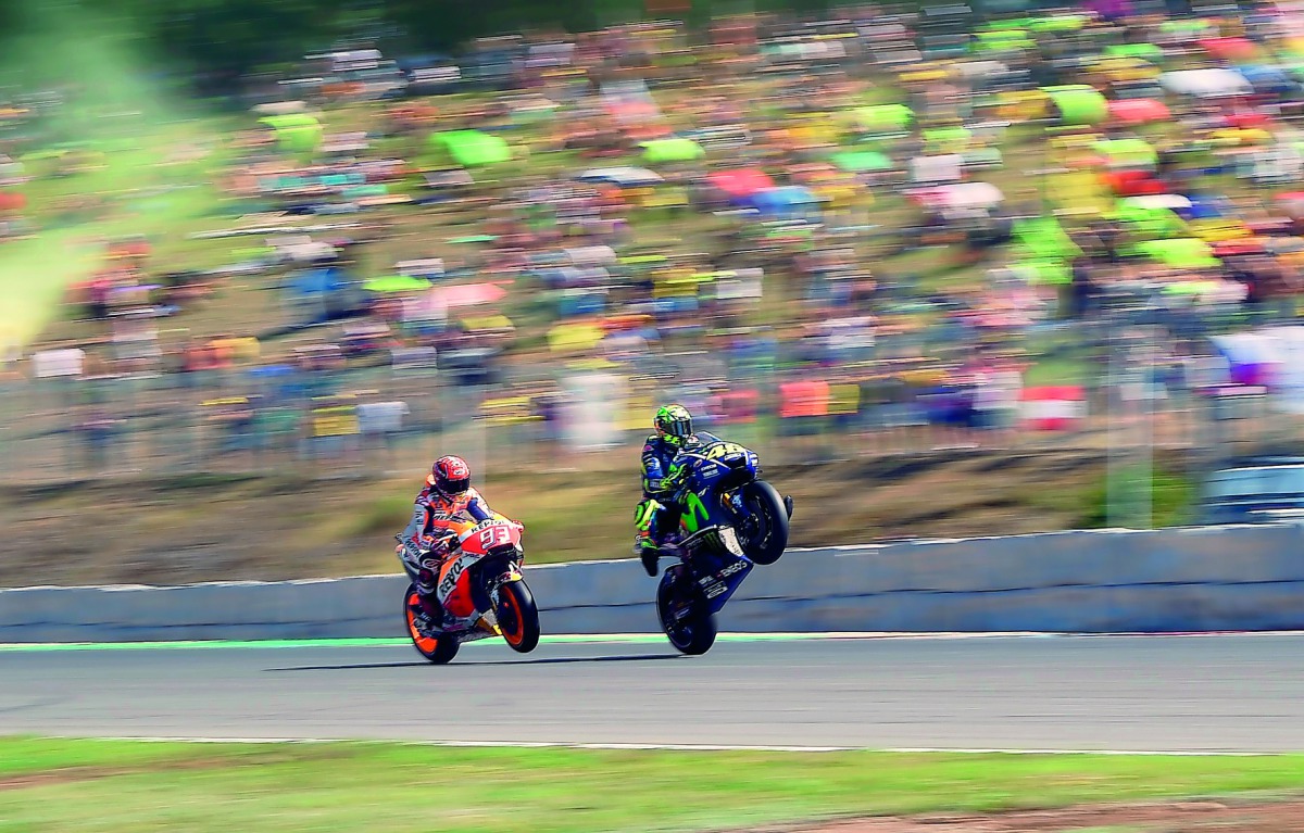 Repsol Honda Team’s Spanish rider Marc Marquez (left) and Movistar Yamaha MotoGP Italian rider Valentino Rossi make wheelies during the qualifying round of the MotoGP Grand Prix of the Czech Republic in Brno yesterday.