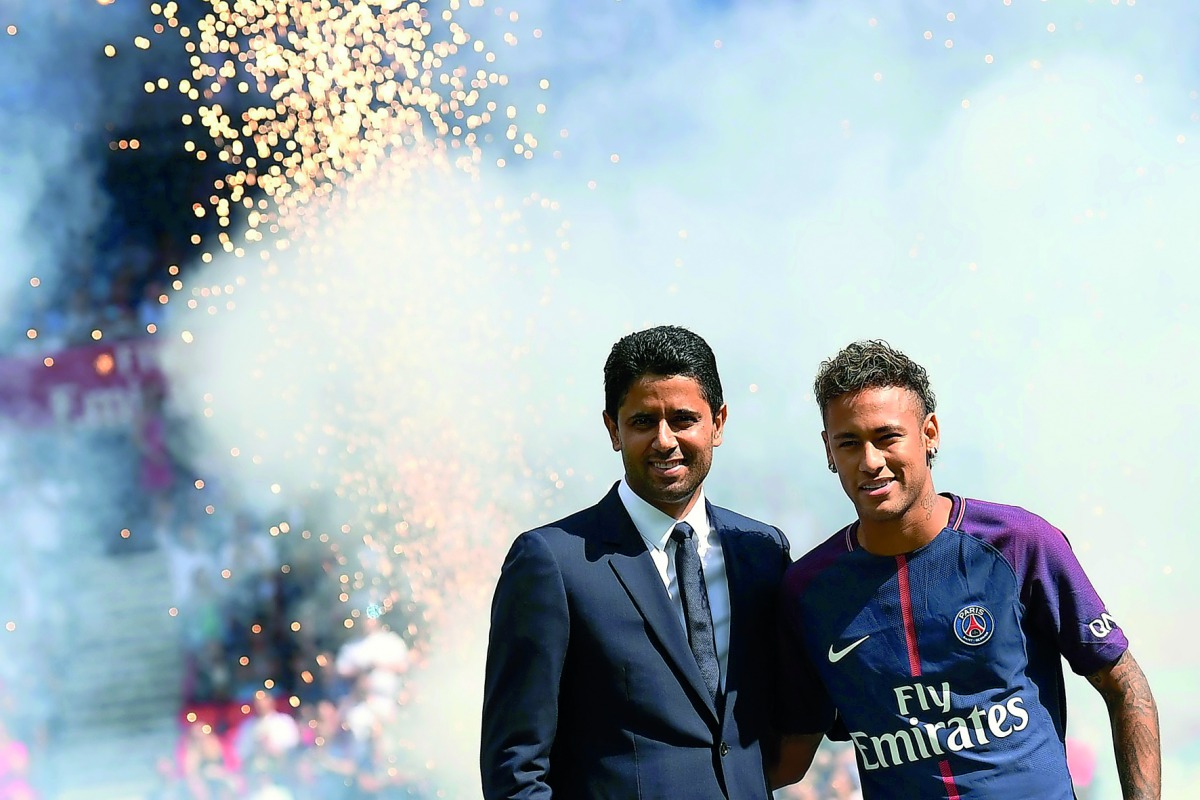 Paris Saint-Germain’s Brazilian forward Neymar (right) poses with Paris Saint Germain’s (PSG) Qatari President Nasser Al Khelaifi during his presentation to the fans at the Parc des Princes Stadium in Paris, on Saturday. 