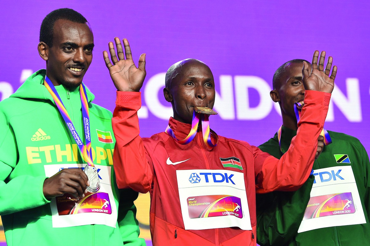 From left: Silver medallist Ethiopia’s Tamirat Tola, gold medallist Kenya’s Geoffrey Kipkorir Kirui and bronze medallist Tanzania’s Alphonce Felix Simbu take part in a medal ceremony after the men’s marathon athletics event at the 2017 IAAF World Champion