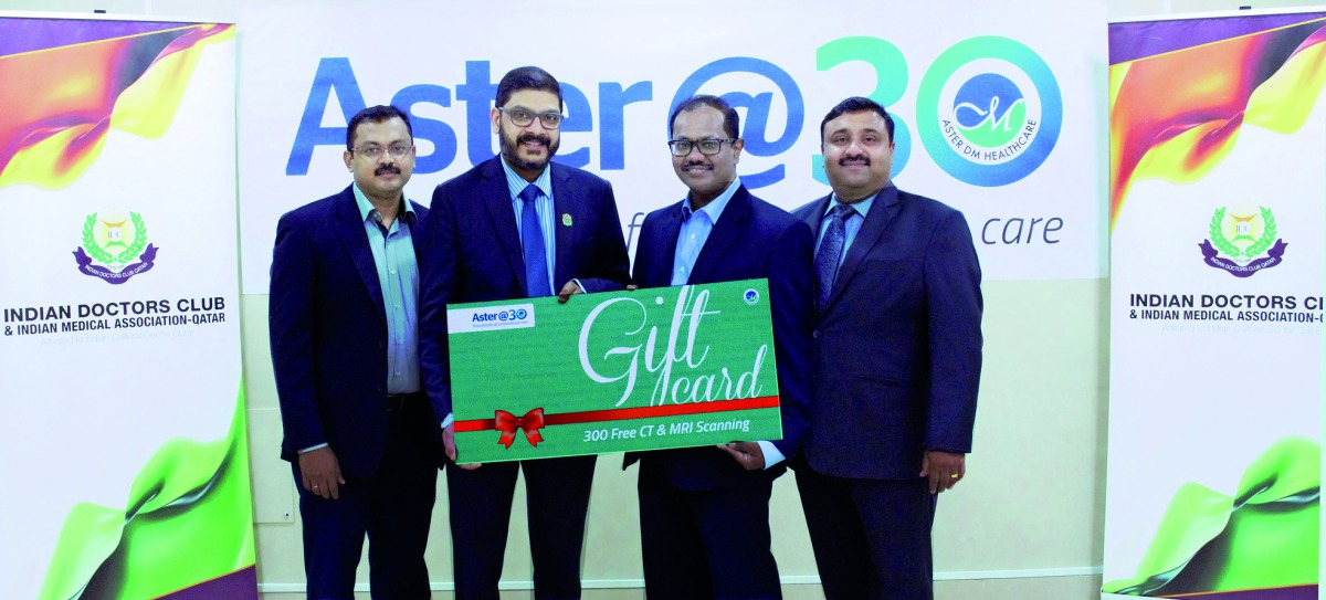 Officials of Aster holding a symbolic voucher.