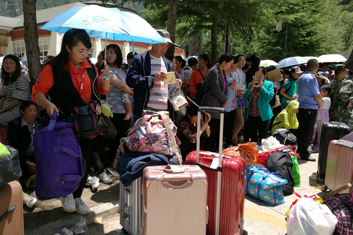 Stranded passengers rest at the departure hall of Jiuzhaigou airport near the remote, mountainous area struck by a deadly earthquake in Sichuan province, China August 9, 2017. REUTERS/Thomas Peter
