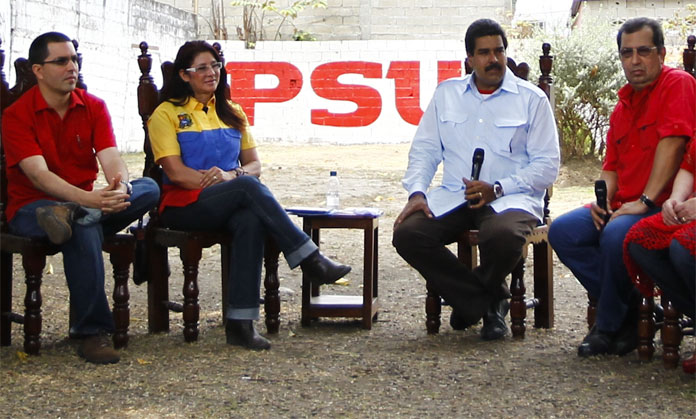 FILE PHOTO: Venezuela's  President Nicolas Maduro (2nd R), his wife Cilia Flores (2nd L) sit with brother of late President Hugo Chavez, governor of Barinas Adan Chavez (R), and President Chavez's son-in-law, Venezuela's Vice President Jorge Arreaza, as t