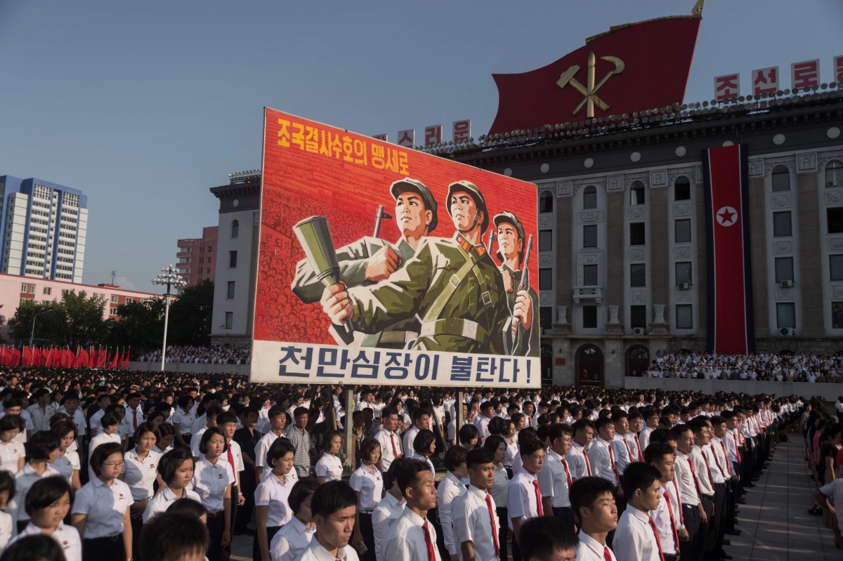 People wave banners and shout slogans as they attend a rally in support of North Korea's stance against the US, on Kim Il-Sung square in Pyongyang on August 9, 2017. AFP / Kim Won-Jin