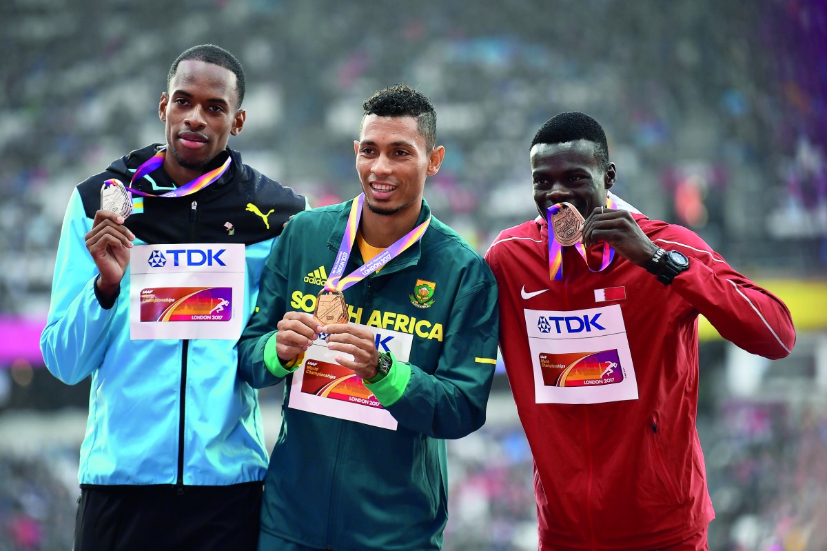 Bronze medallist Abdalelah Haroun of Qatar (right) Silver medallist Steven Gardiner of the Bahamas (left) and gold medallist Wayde Van Niekerk of South Africa pose with their medals during the victory ceremony of the Men’s 400 metres of the IAAF Athletics