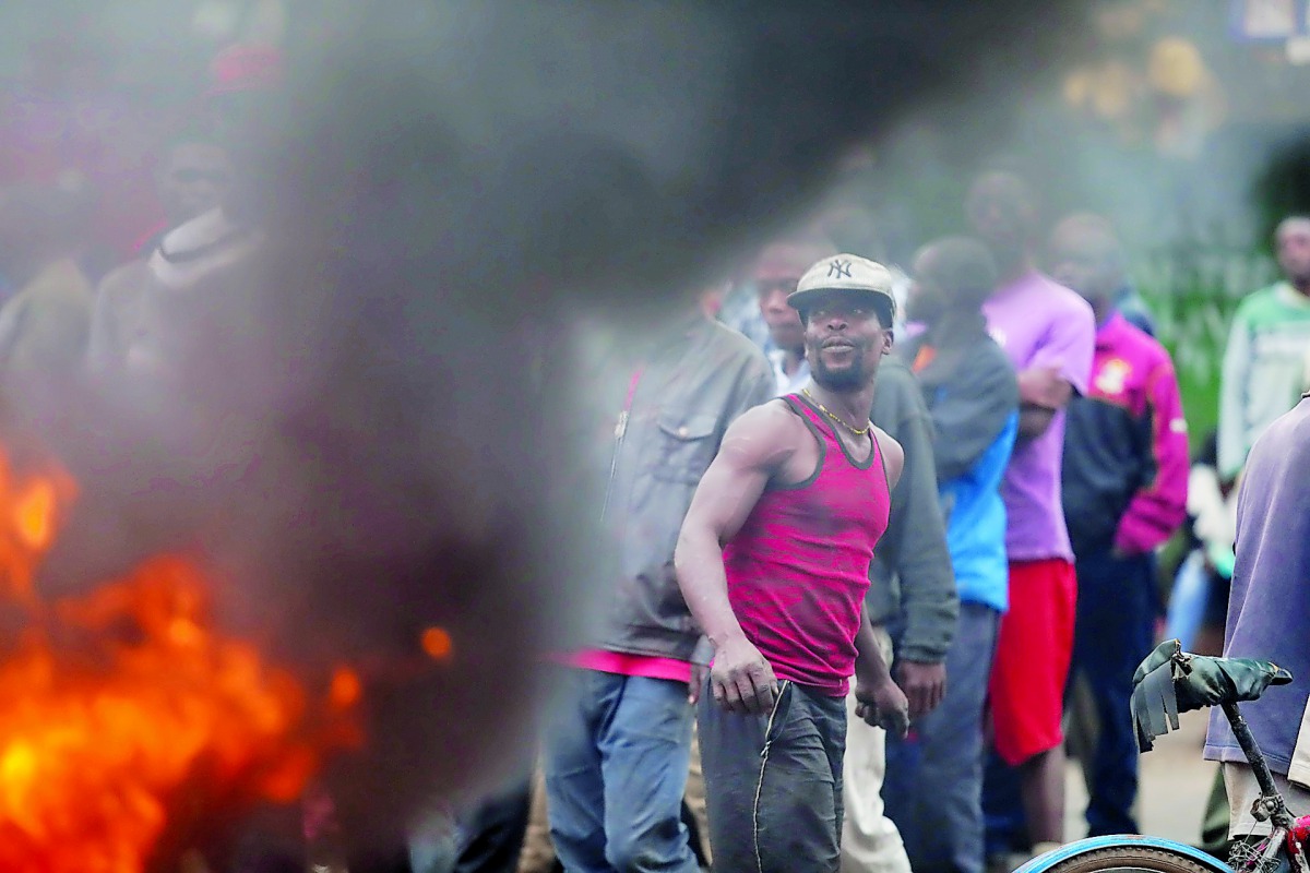 Supporters of the opposition candidate Raila Odinga stage protest against the election results in the slum neighbourhood of Nairobi, Kenya, yesterday.
