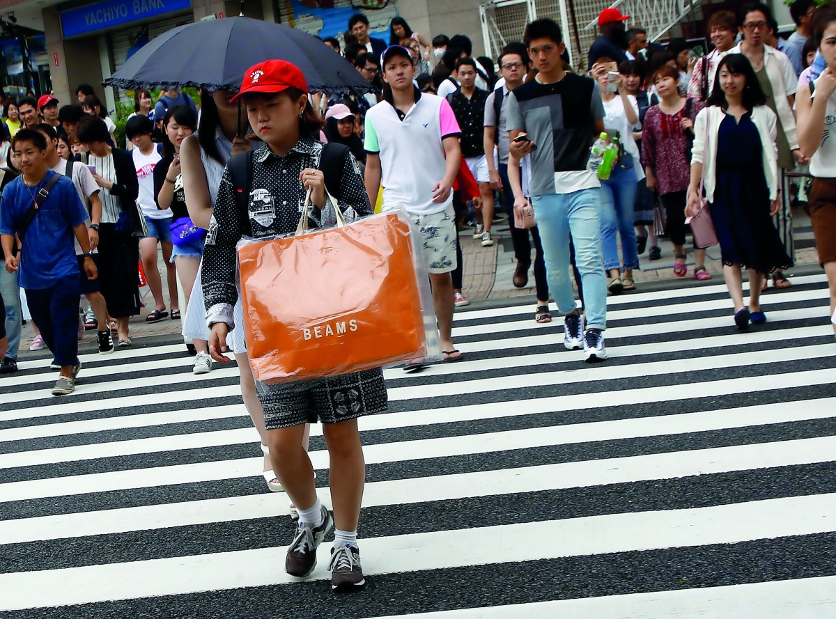 A woman carries a shopping bag at a shopping district in Tokyo, yesterday.