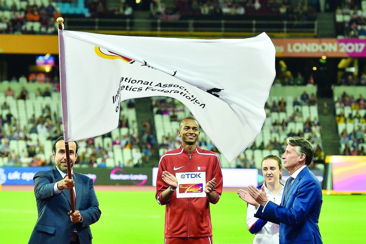 Qatar Athletics Federation and Vice-President of the Doha 2019 Organising Committee, Dr Thani Abdulrahman Al Kuwari waves the IAAF flag during the official flag handing over ceremony at the end of the IAAF World Championships in London on Sunday, watched 