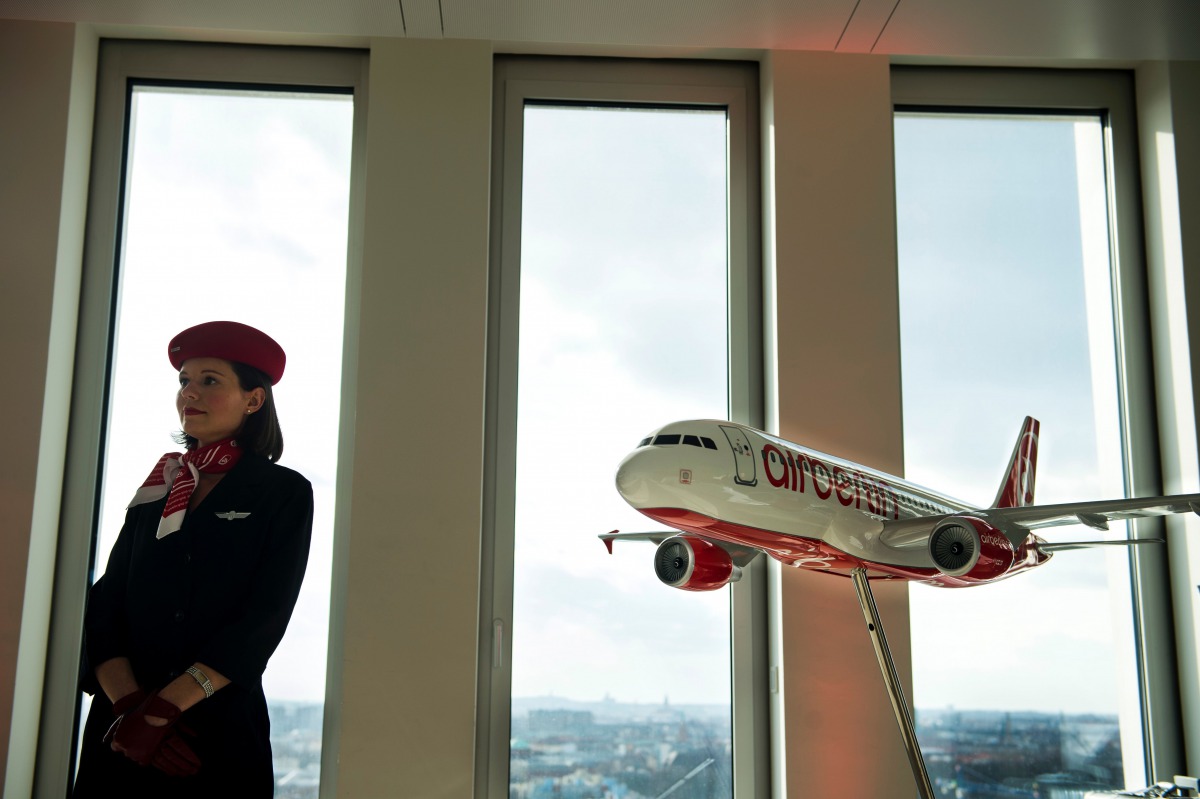 An hostess standing next to a model airplane of German airline Air Berlin. (AFP / ODD ANDERSEN / File photo)