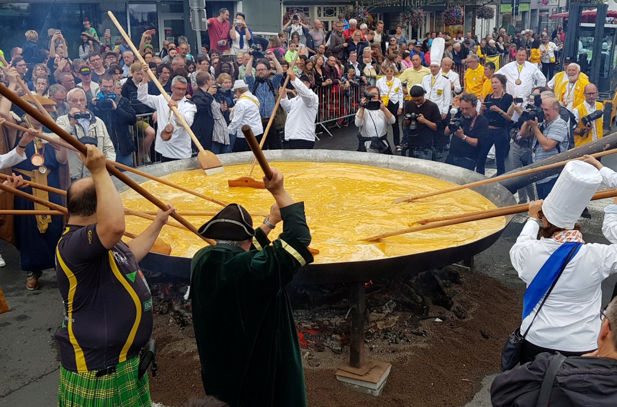 Members of the worldwide fraternity of the omelette prepare a traditional giant omelette made with 10,000 eggs in Malmedy, Belgium August 15, 2017. Reuters/Christopher Stern