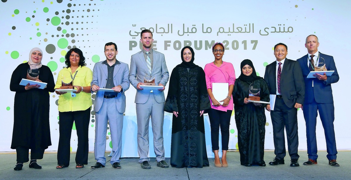 Buthaina A Al Nuaimi (centre), President of PUE, QF, alongside the recipients of the annual forum awards at the Qatar National Convention Center. 
