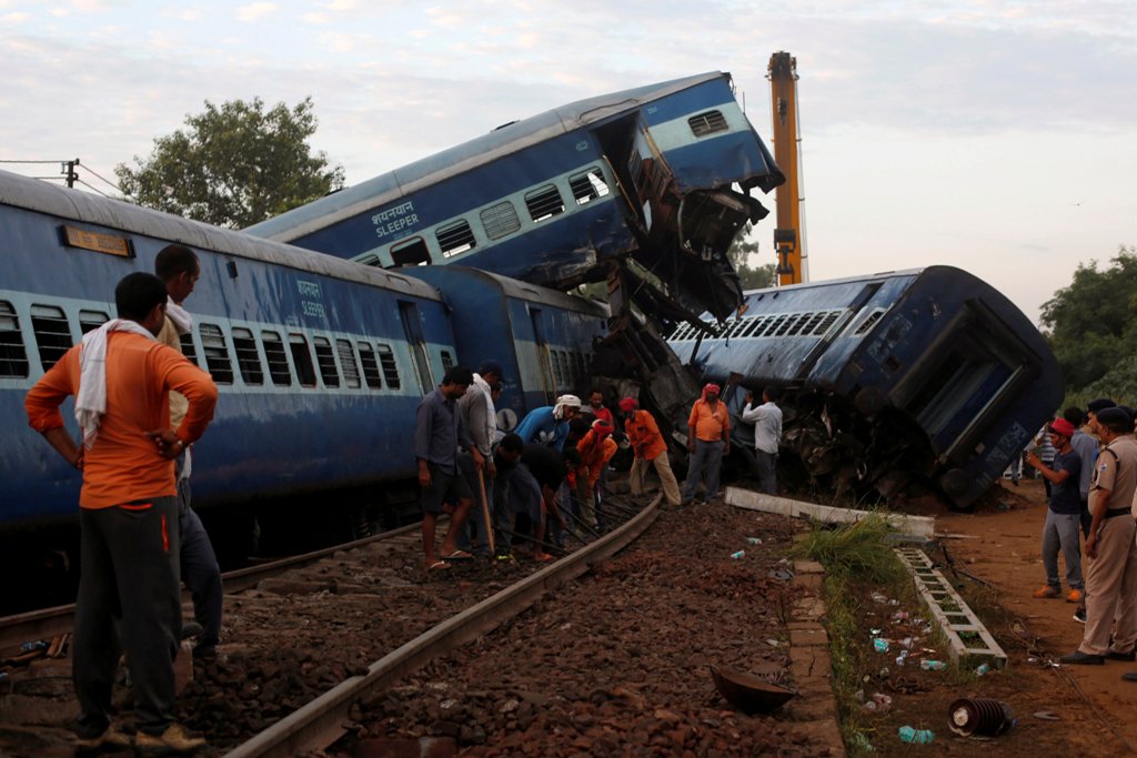 Railway workers repair the tracks next to derailed coaches of a passenger train at the site of an accident in Khatauli, in the northern state of Uttar Pradesh, India August 20, 2017. REUTERS/Adnan Abidi.