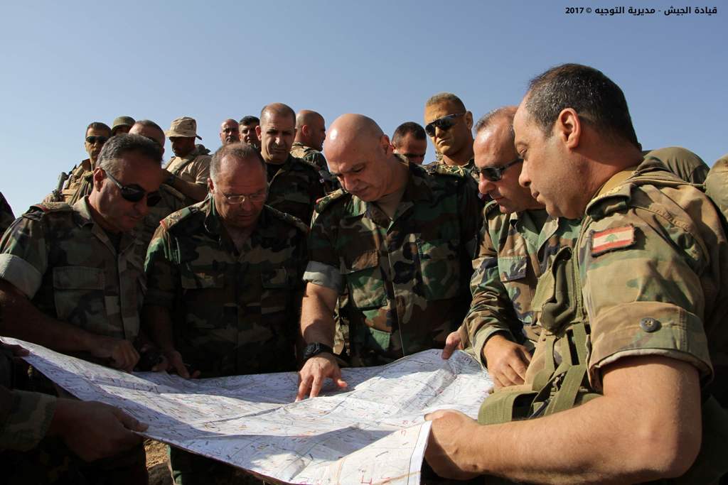 A handout picture released by the Lebanese Army on August 20, 2017, shows Army Commander Joseph Aoun (C) speaking soldiers in Ras Baalbek during an operation against jihadist fighters.
