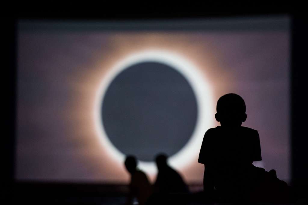 Children watch a presentation about the eclipse during a drive-in movie at the Historic Columbia Speedway August 20, 2017 in Columbia, South Carolina.  Sean Rayford/AFP