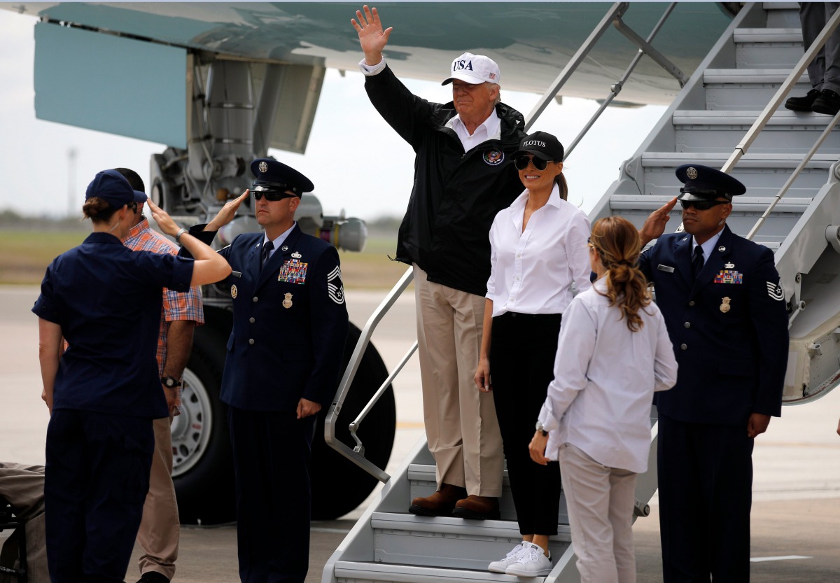 U.S. President Donald Trump (C) waves next to first lady Melania Trump upon arrival prior to receiving a briefing on Tropical Storm Harvey relief efforts in Corpus Christi, Texas, U.S., August 29, 2017. REUTERS/Carlos Barria