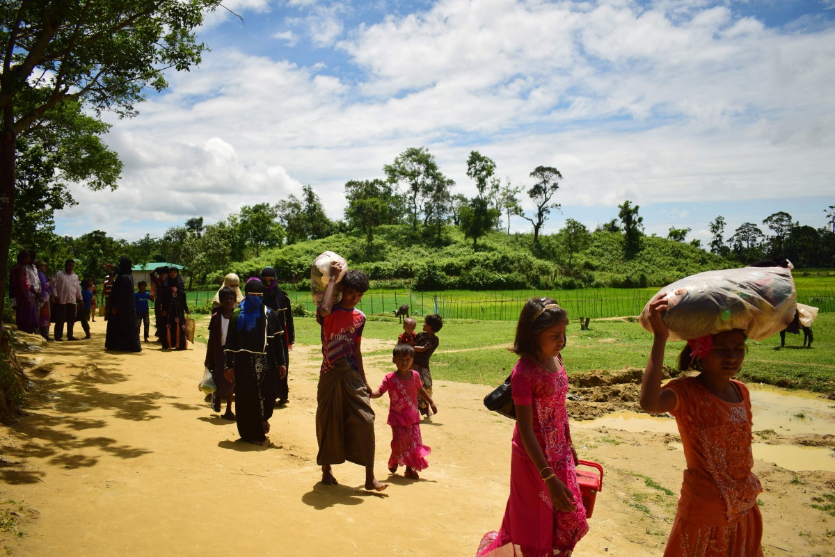 Rohingya refugees walk pass Balukhali refugee camp near Myanmar border in Bangladesh on August 27, 2017. AFP / Sam Jahan