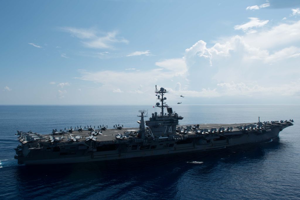 This US Navy file handout photo obtained August 30, 2017 shows an MH-60R Sea Hawk piloted by Cmdr. Paul D. Will (top), breaking formation during an aerial change of command ceremony above USS John C. Stennis (CVN 74)on May 20, 2016 in the South China Sea.