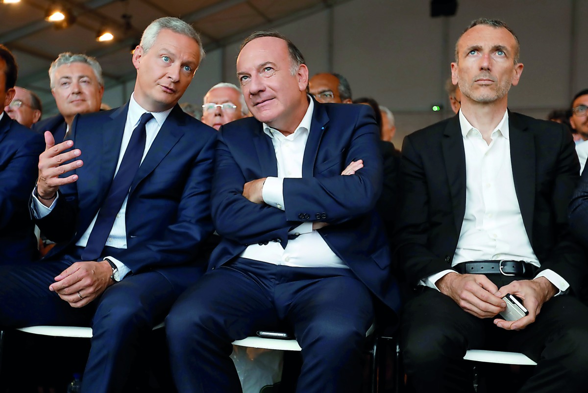 French employer’s body MEDEF union leader, Pierre Gattaz (centre), speaks with French Finance Minister, Bruno Le Maire (left), next to Emmanuel Faber, Chief Executive Officer of French food group Danone, at the MEDEF union summer forum at the campus of th