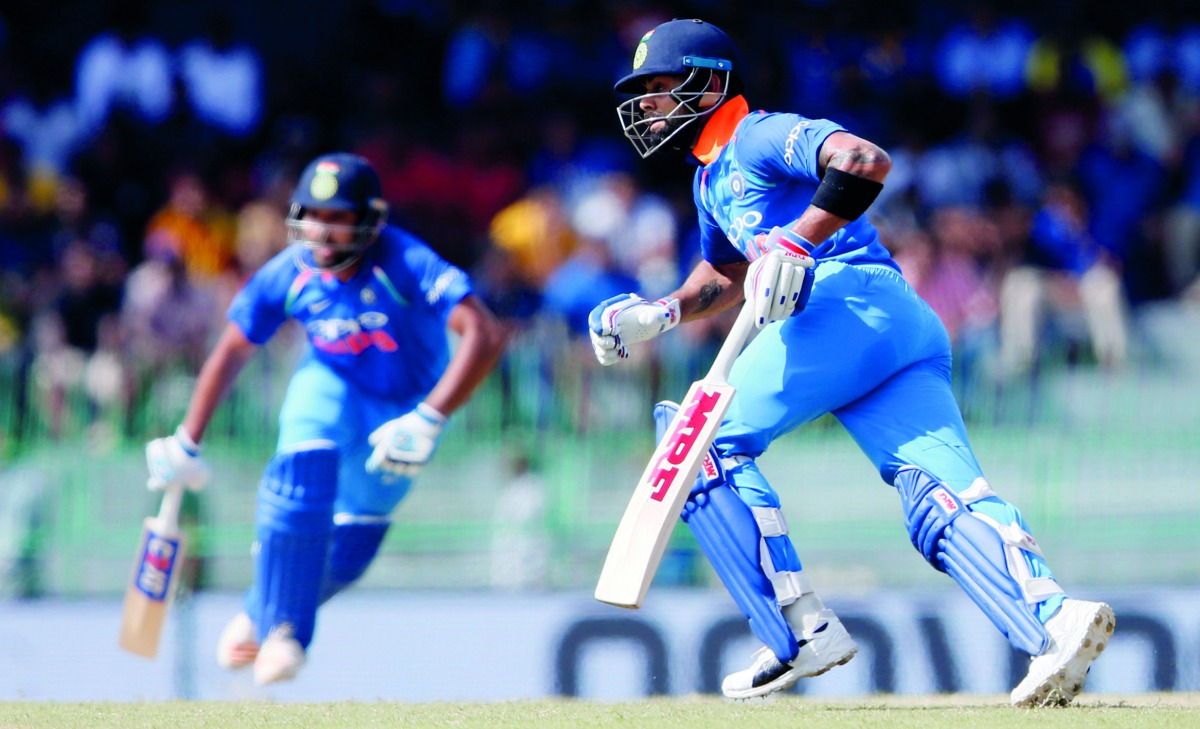 Team Indian captain Virat Kohli and team-mate Rohit Sharma  run between wickets during the fourth One Day International match against Sri Lanka at the R Premadasa Stadium in Colombo, Sri Lanka yesterday. India rode on centuries by Kohli and Sharma to thra