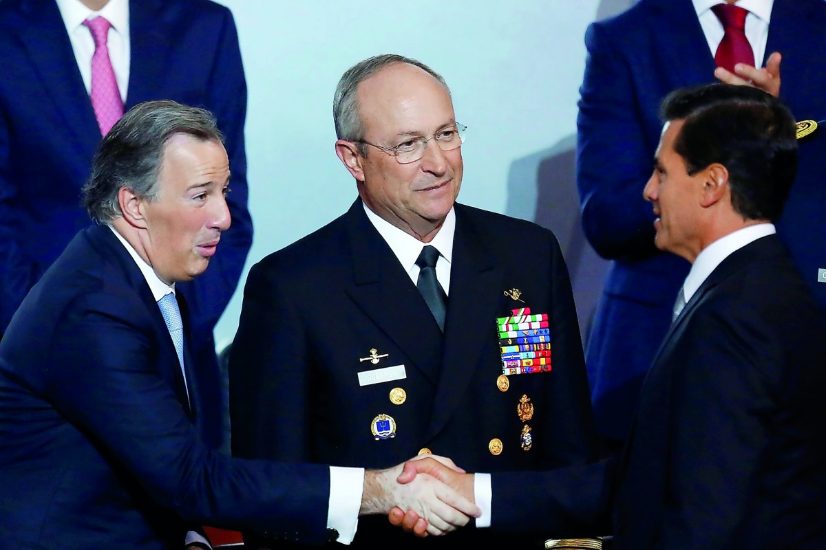 Mexico's President Enrique Pena Nieto greets Finance Minister Jose Antonio Meade (R) as Mexican Secretary of Navy Admiral Vidal Francisco Soberon Sanz (C), looks on after his annual address to the nation in Mexico City, Mexico September 2, 2017. REUTERS/C