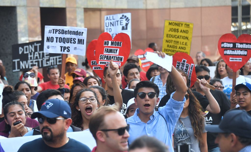 Young immigrants and supporters walk holding signs during a rally in support of Deferred Action for Childhood Arrivals (DACA) in Los Angeles, California on September 1, 2017.  AFP / FREDERIC J. BROWN
