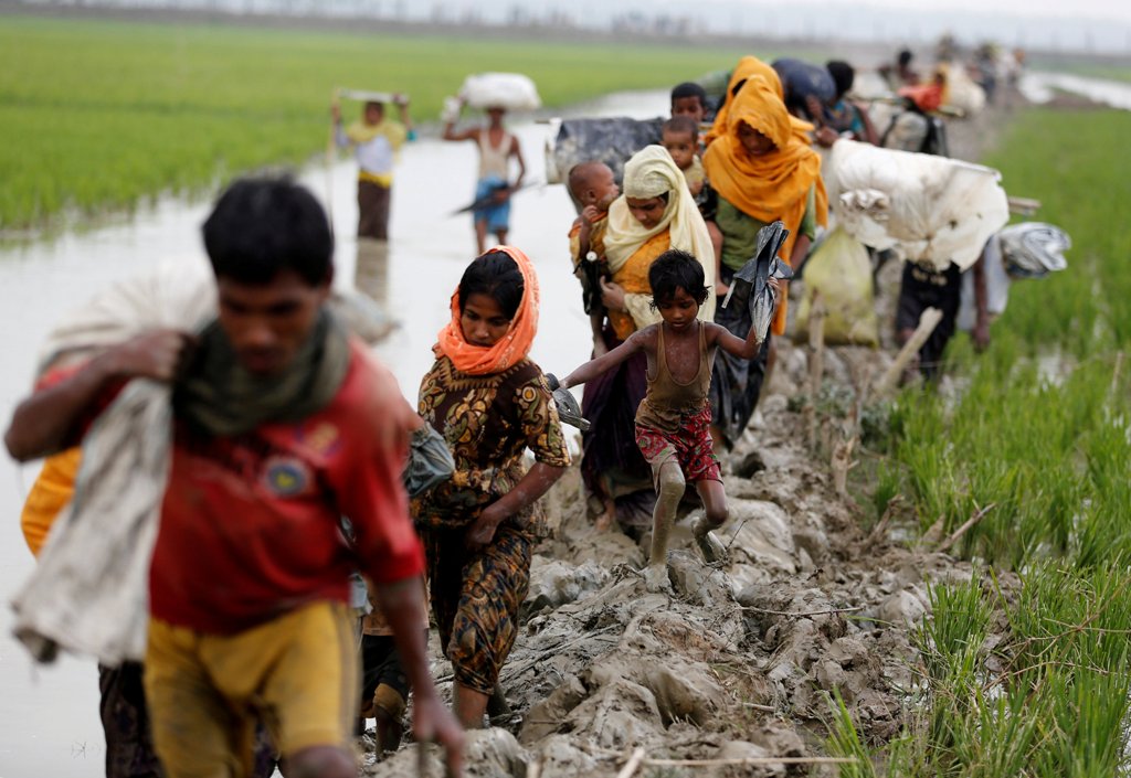 Rohingya refugees walk on the muddy path after crossing the Bangladesh-Myanmar border in Teknaf, Bangladesh, September 3, 2017. REUTERS/Mohammad Ponir Hossain
