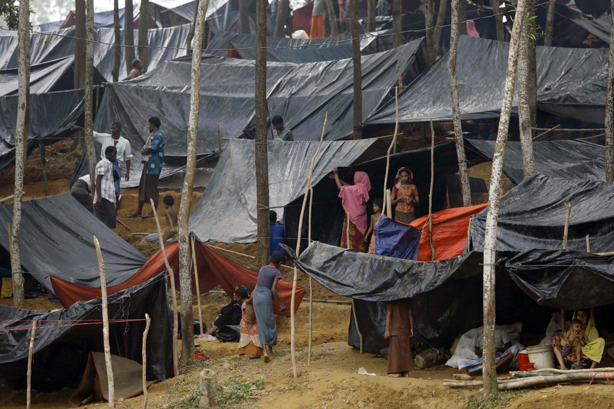 Rohingya refugees from Myanmar's Rakhine state shelter under makeshift tents after arriving at a refugee camp near the Bagladeshi town of Teknaf on Septebmer 5, 2017. (AFP / K M ASAD)