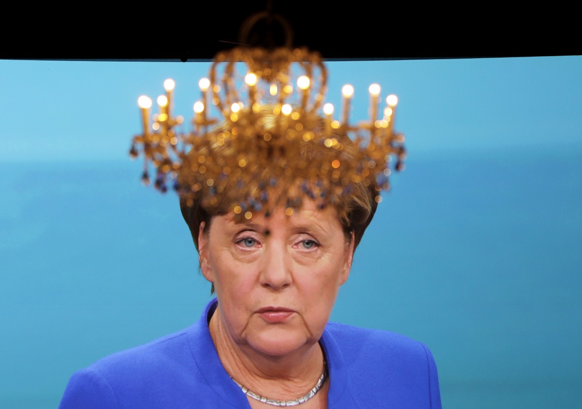 A chandelier hangs in front of a giant TV screen showing German Chancellor Angela Merkel going head-to-head with her fiery challenger Martin Schulz of teh Social Democratic party (SPD) in their only television debate before this month's general elections,