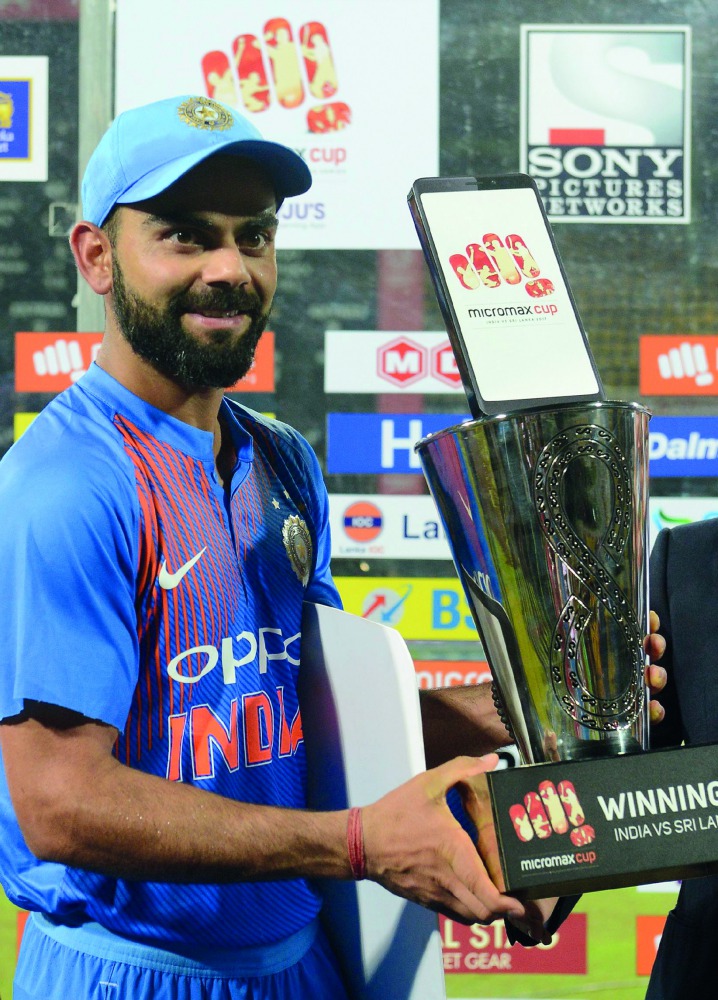 Indian cricket captain Virat Kohli poses with the trophy after winning the Twenty20 match against Sri Lanka at R Premadasa Stadium in Colombo, yesterday.