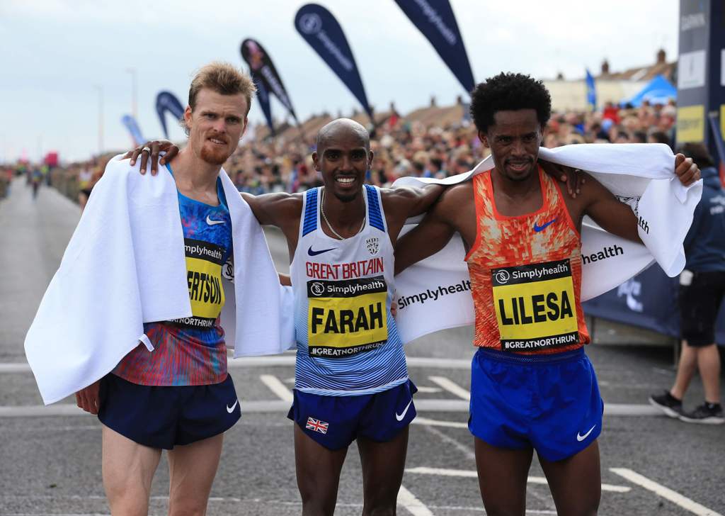 (L-R) Second-placed New Zealand's Jake Robertson, winner Britain's Mo Farah and third-placed Ethiopia's Feyisa Lilesa pose at the finish line after finishing the men's elite race of the Great North Run half-marathon in South Shields, north east England on