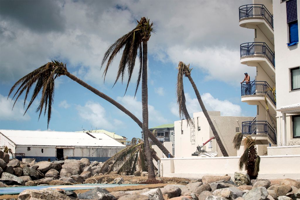 This handout photograph provided courtesy of the Dutch Department of Defense on September 8, 2017 shows a man looking on over the devastion of Hurricane Irma on the Dutch Caribbean island of Sint Maarten. AFP PHOTO / DUTCH DEFENSE MINISTRY