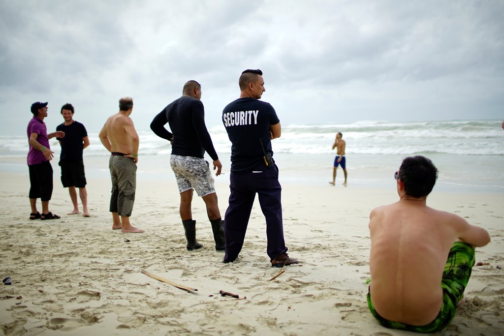 Tourists and a security agent are seen on a beach a day after the passage of Hurricane Irma in Varadero, Cuba, September 10, 2017. REUTERS/Alexandre Meneghini
