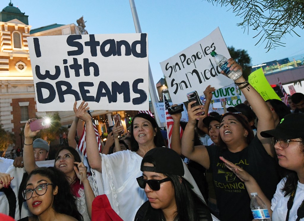 LAS VEGAS, NV: Immigrants and supporters chant outside the New York-New York Hotel & Casino on the Las Vegas Strip during a 