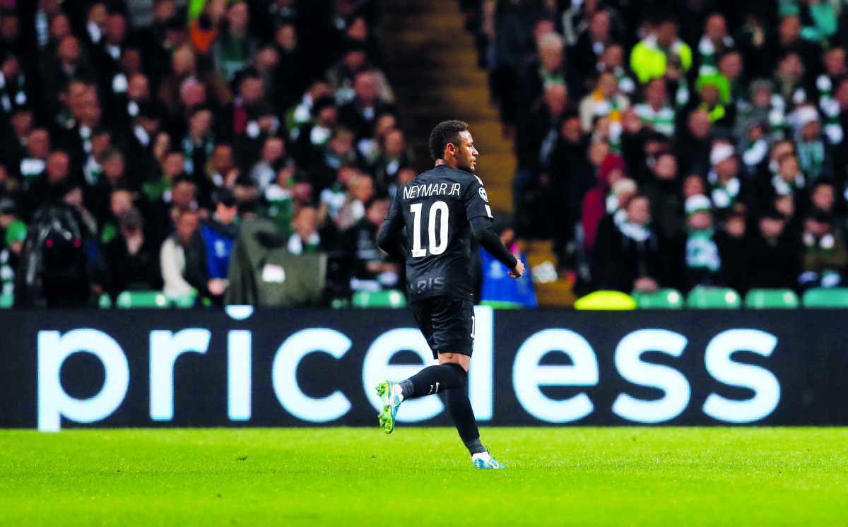 Paris Saint-Germain’s Neymar celebrates after scoring their first goal against Celtic during their opening Champions League Group B match played at Celtic Park in Glasgow, Britain yesterday. Paris St Germain won 5-0 as the world’s most expensive frontline