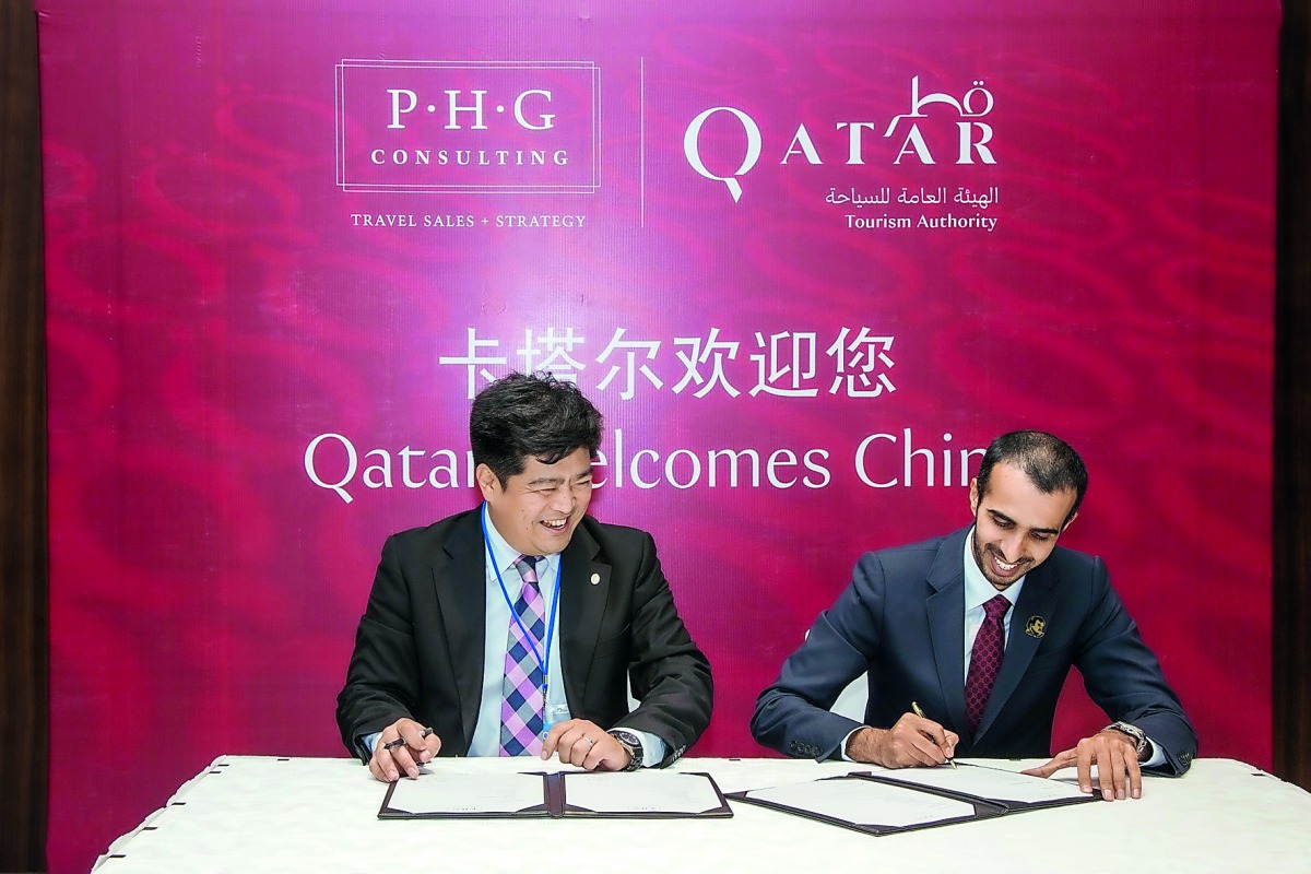 Officials from Qatar and China signing the agreement.