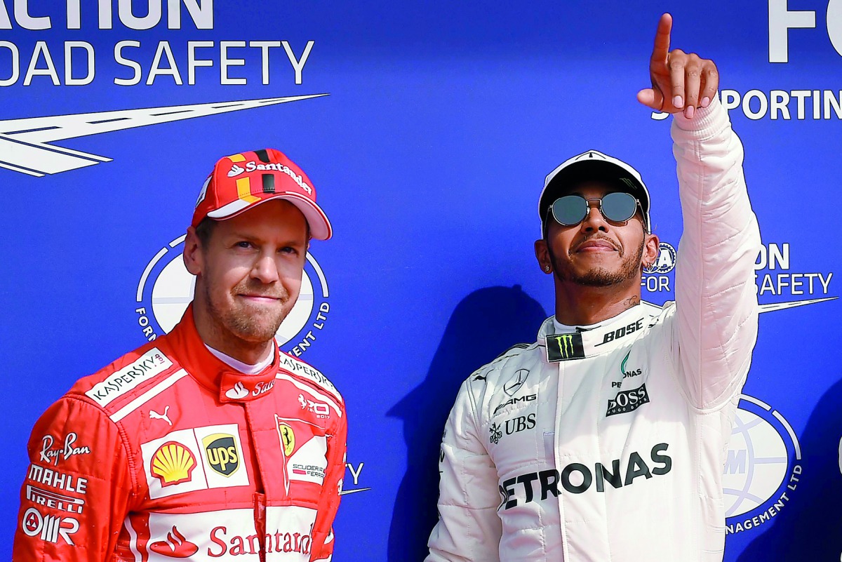Mercedes driver Lewis Hamilton (right) celebrating his pole position next to second placed Ferrari driver Sebastian Vettel after the qualifying session at the Spa-Francorchamps circuit in Spa ahead of the Belgian Formula One Grand Prix in the August 2017 