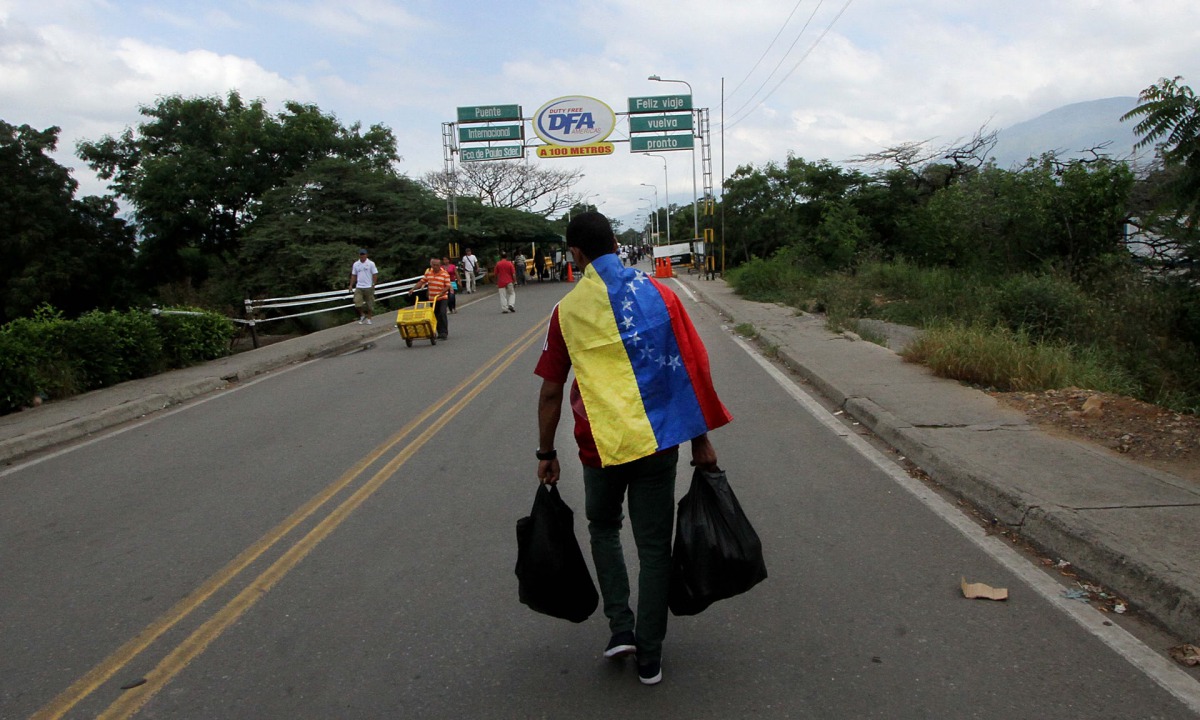Filephoto of a man crossing the Francisco de Paula Santander international bridge, linking Urena, Venezuela, and Cucuta, Colombia. George Castellanos/AFP/Getty Images
 