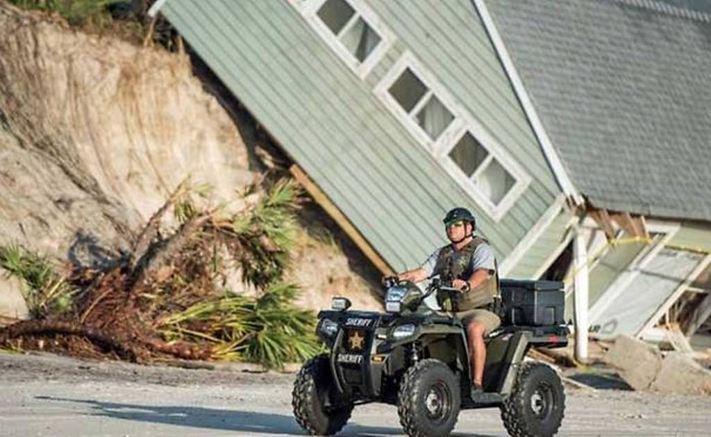 A sheriff's officer passes by a beachfront home destroyed by Hurricane Irma in Vilano Beach, Florida. (Sean Rayford/Getty Images/AFP).