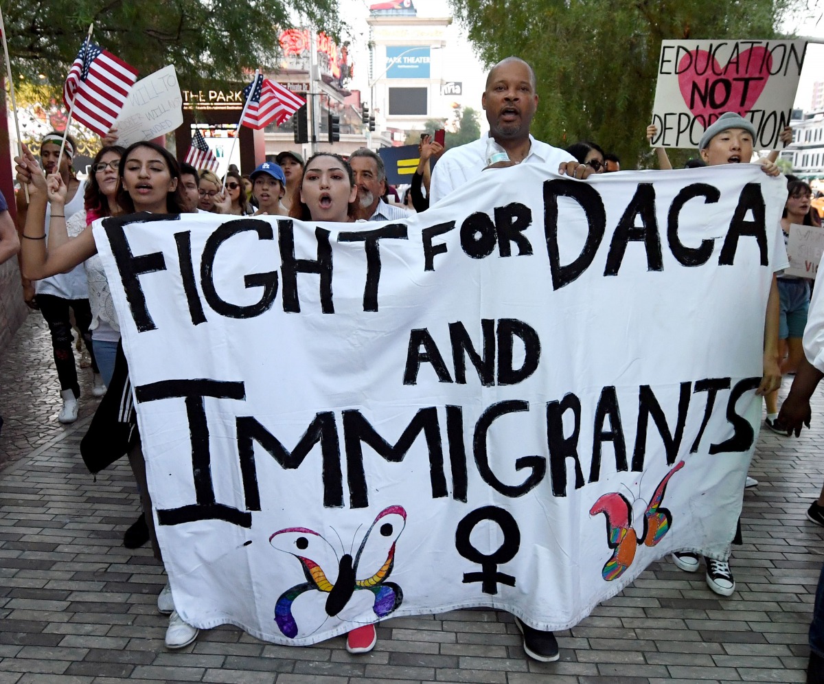 Nevada Senate Majority Leader Aaron D. Ford (D-Las Vegas) (3rd L) joins immigrants and supporters as they march on the Las Vegas Strip during a 