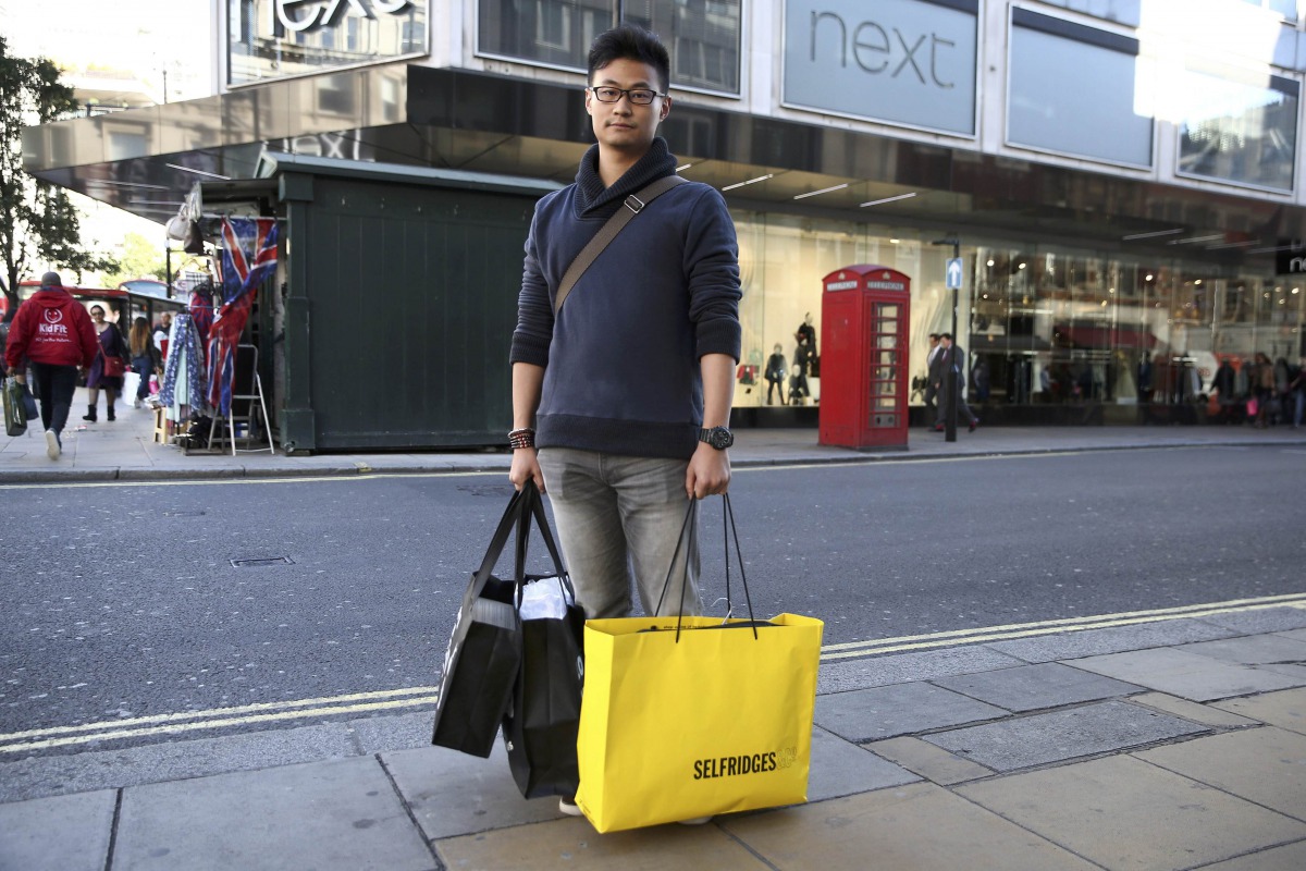 A Chinese tourist, Jasper Zhang, poses for a portrait on New Bond Street in London, October 5, 2016.  Reuters/Neil Hall