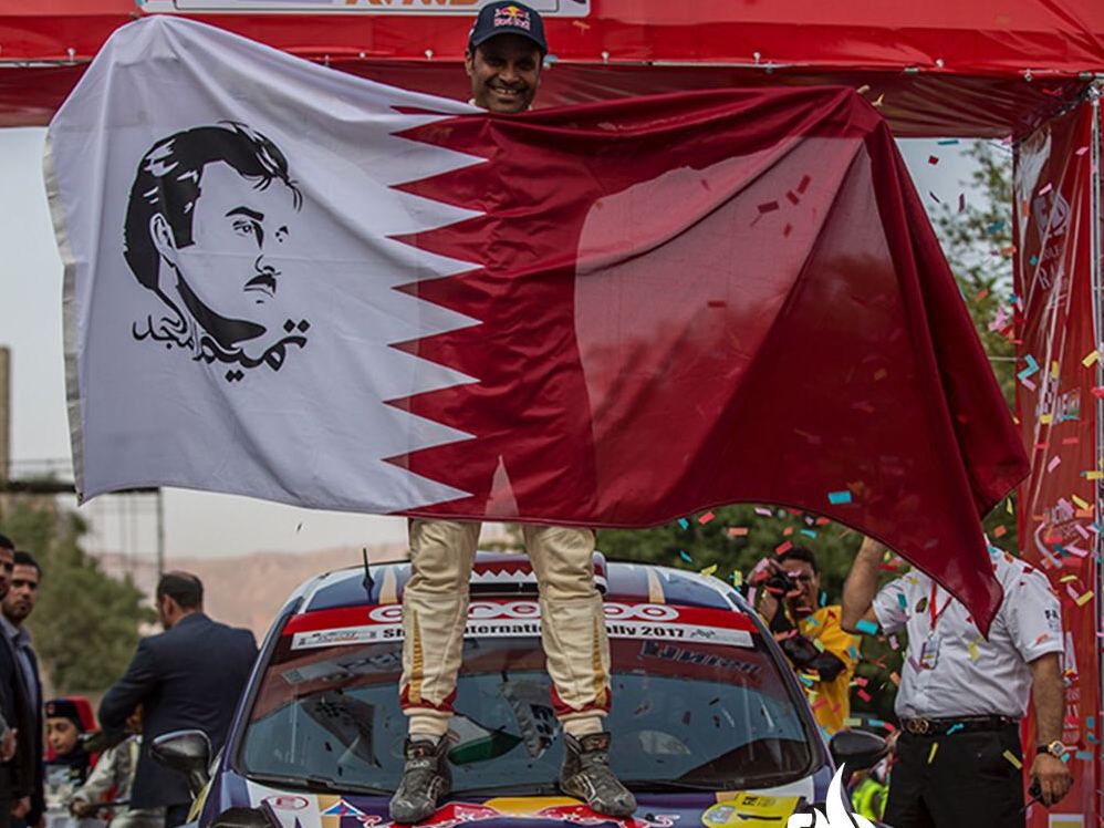 Qatari rally driver Nasser Saleh Al Attiyah pose for a photograph after winning the Shiraz International Rally in south-central Iran, on Friday.