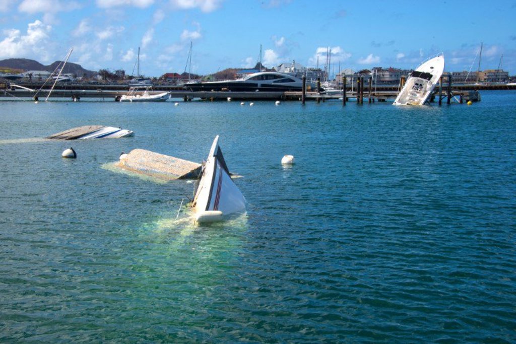 Boats and yatchs are seen sunk and damaged in a harbour on the French Caribbean island of Saint Martin on September 17, 2017, after the island was hit by Hurricane Irma. AFP.