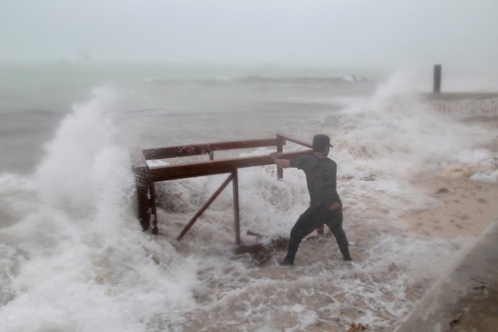 A man tries to salvage a table belonging to his restaurant before the arrival of Hurricane Maria in Punta Cana, Dominican Republic, September 20, 2017. REUTERS/Ricardo Rojas

