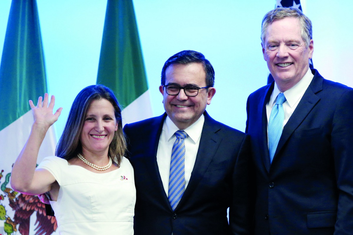 FILE PHOTO: Canadian Foreign Minister Chrystia Freeland, Mexico's Economy Minister Ildefonso Guajardo and U.S. Trade Representative Robert Lighthizer smile as they pose for a photo after addressing the media to close the second round of NAFTA talks involv