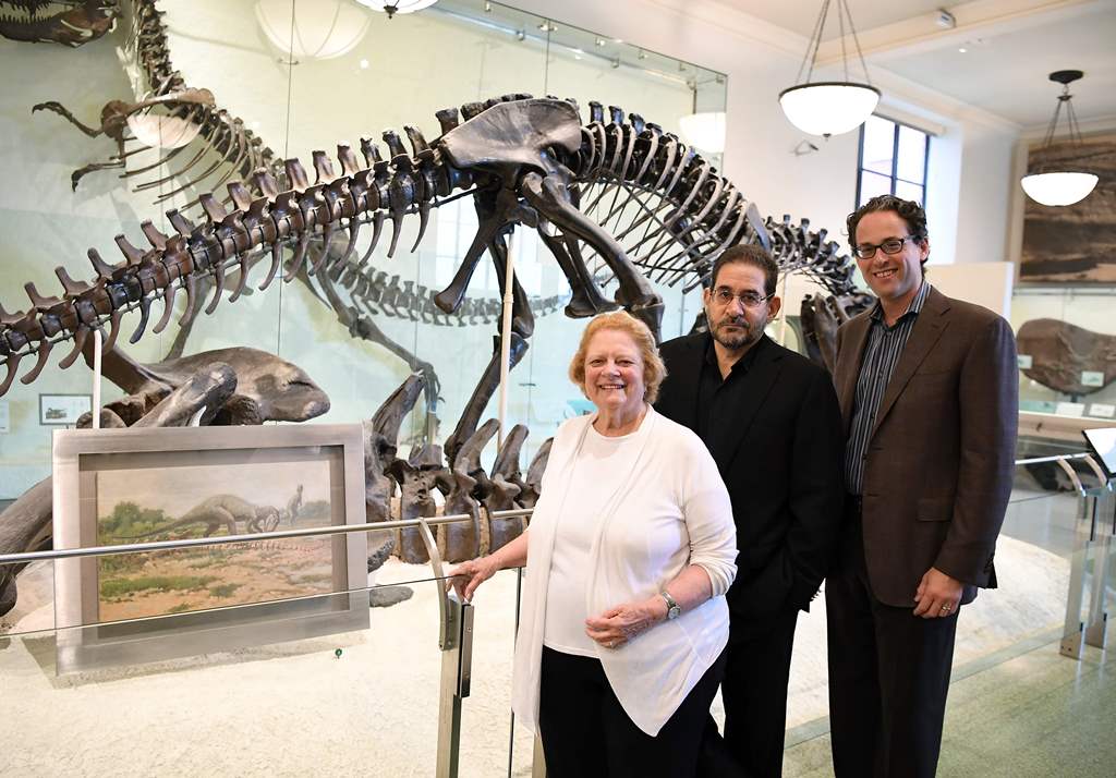 From L to R: Rhoda Knight Kalt, composer John Musto and librettist Eric Einhorn pose for a picture during an interview at the Dinosaur Hall of the American Museum of Natural History in New York City on September 18, 2017. AFP / ANGELA WEISS 