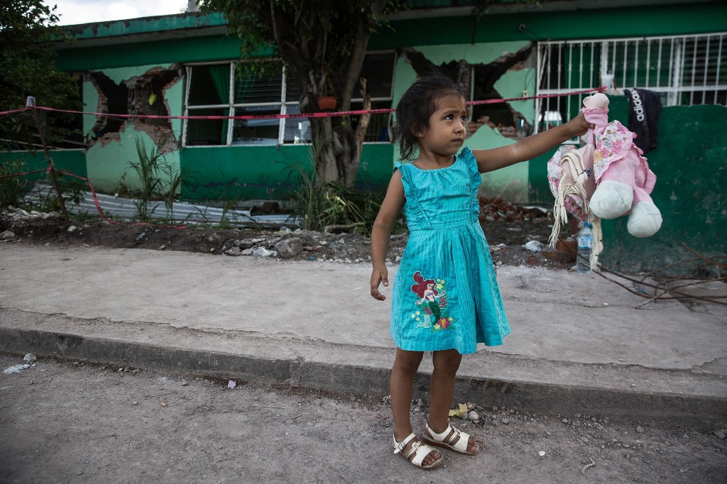 JOJUTLA, MEXICO: A girl is seen outside a collapsed primary school, 5 days after a 7.1 earthquake in Jojutla, Morelos state, Mexico on September 24, 2017. (Daniel Cardenas - Anadolu Agency)