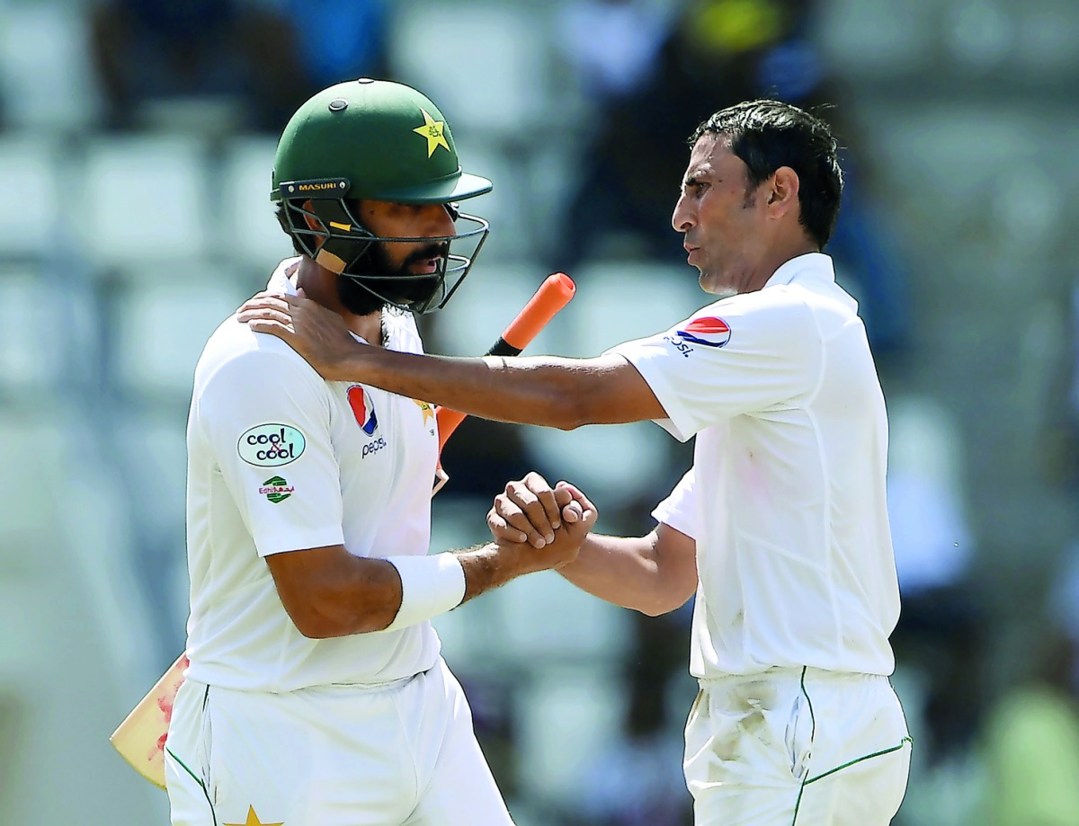Pakistan captain Misbah ul Haq (left) is greeted by team-mate and fellow retiree Younis Khan on the fourth day’s play of the final Test match against the West Indies at the Windsor Park Stadium in Roseau, Dominica in this May 2017 file photo.