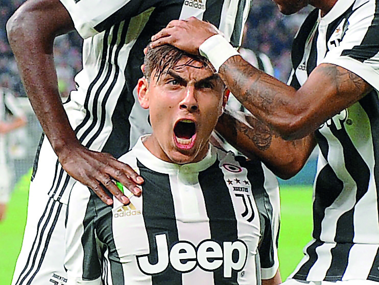 Juventus’ Paulo Dybala celebrates after scoring their first goal against Torino in their Serie A match at Juventus Stadium on Saturday.